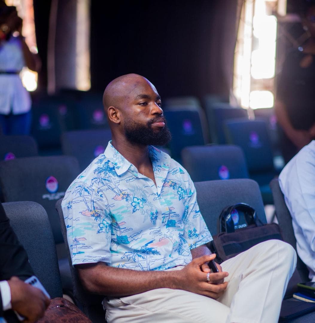 David Ejere seated in the front row at an event